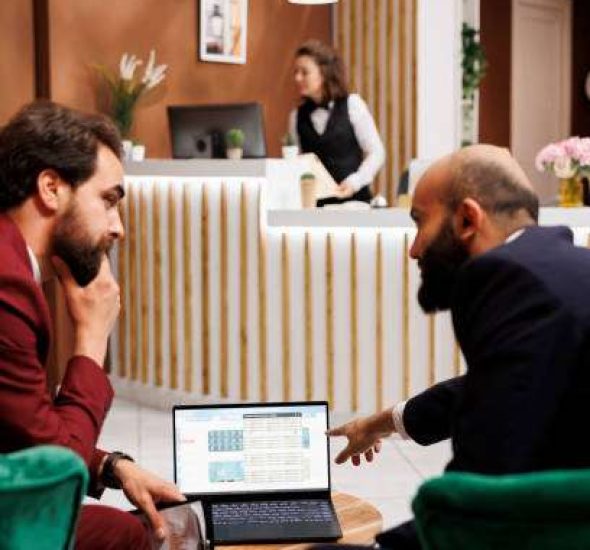 Business partners exchange plans at international meeting, discussing about future partnership in lounge area lobby. Professionals in suits looking to create common goals for collab.